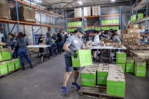 Man loading HelloFresh Meals with Meaning boxes on a pallet