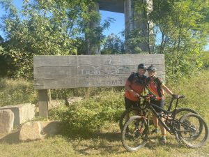 Gail and her husband spending time together, mountain biking.