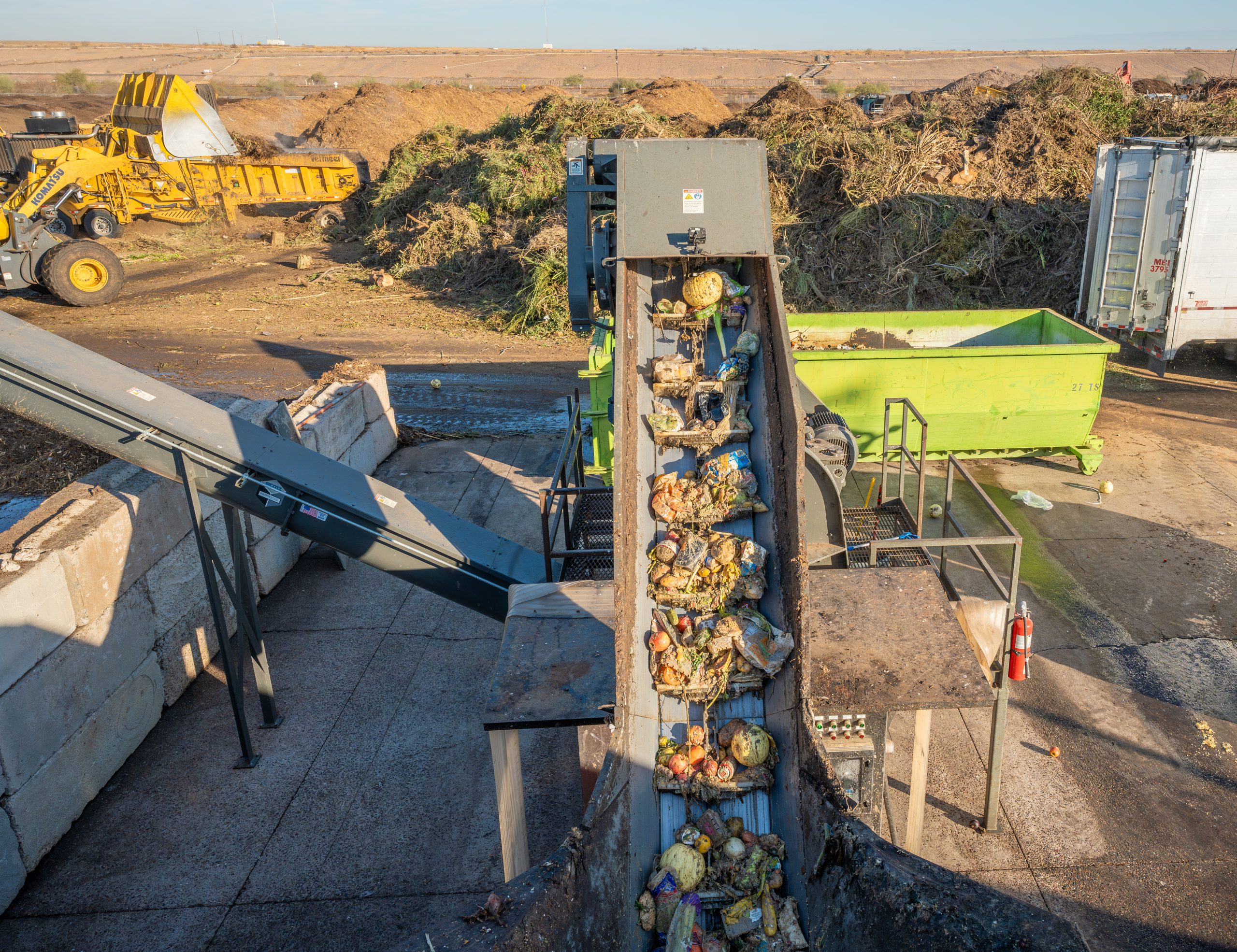 Food enters a Denali depackaging machine.