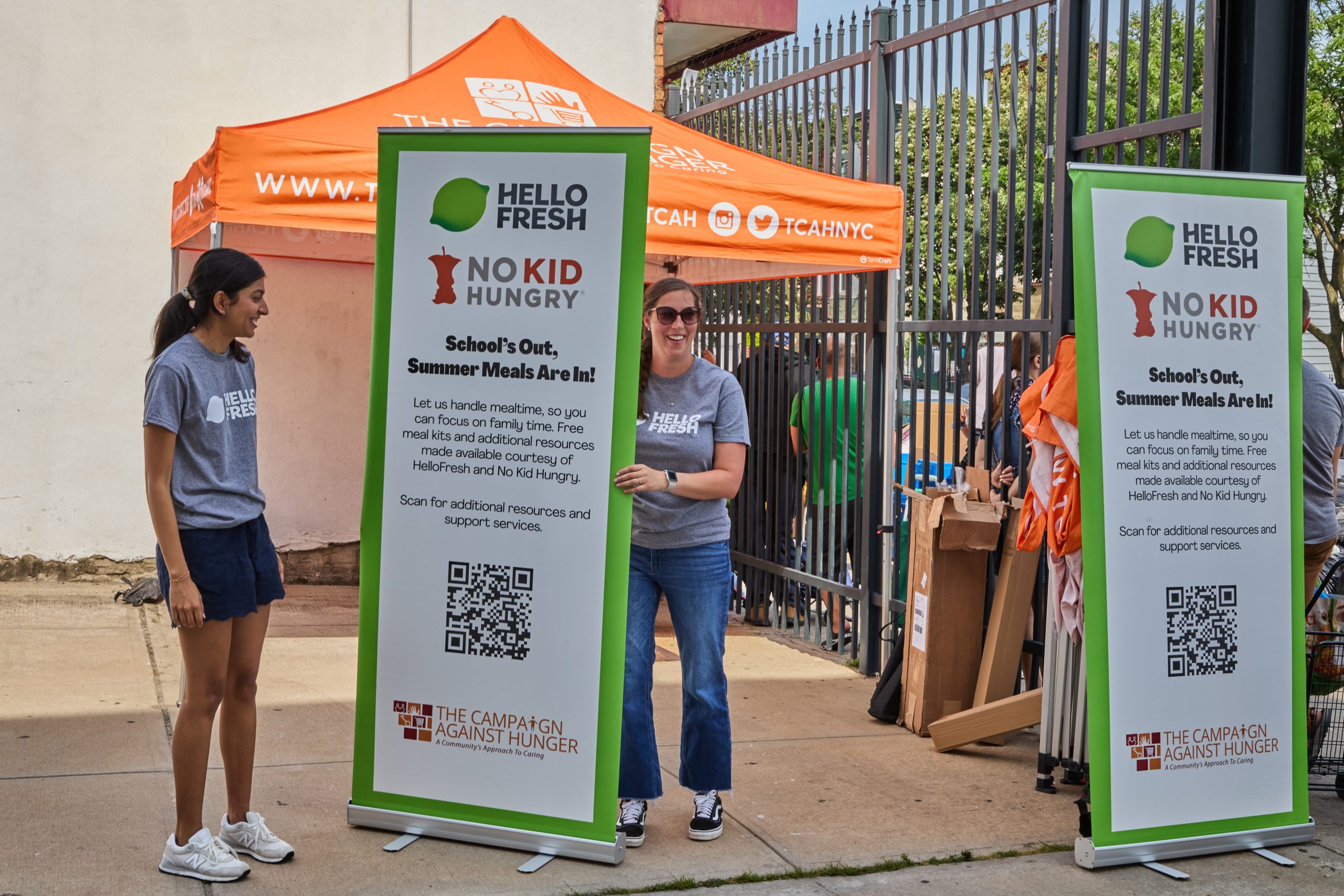 HelloFresh employees hold a sign in partnership with NoKidHungry to fight against childhood hunger