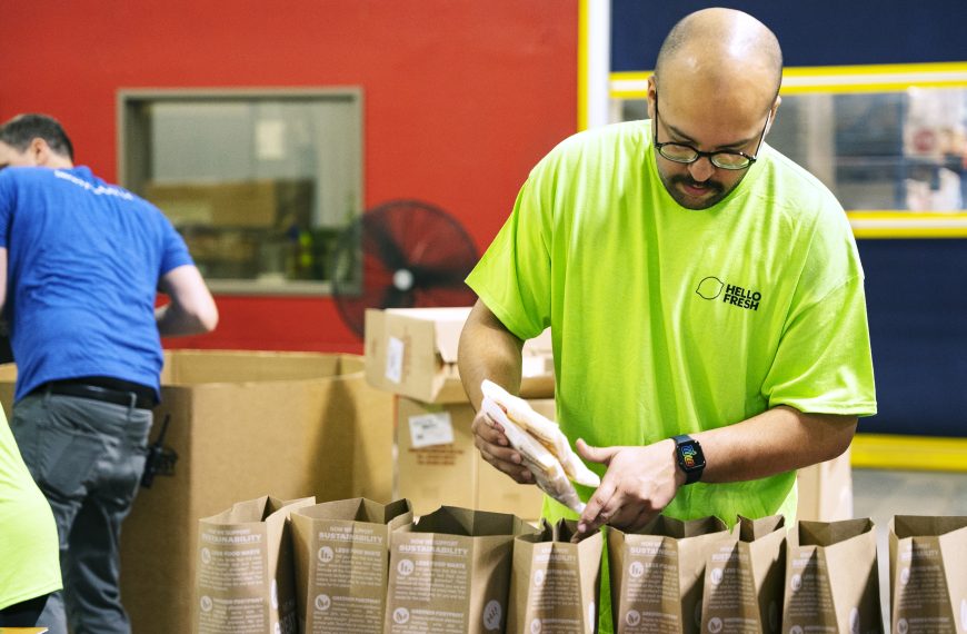 A HelloFresh team member packs donation bags, helping to provide nutritious meals to those in need.