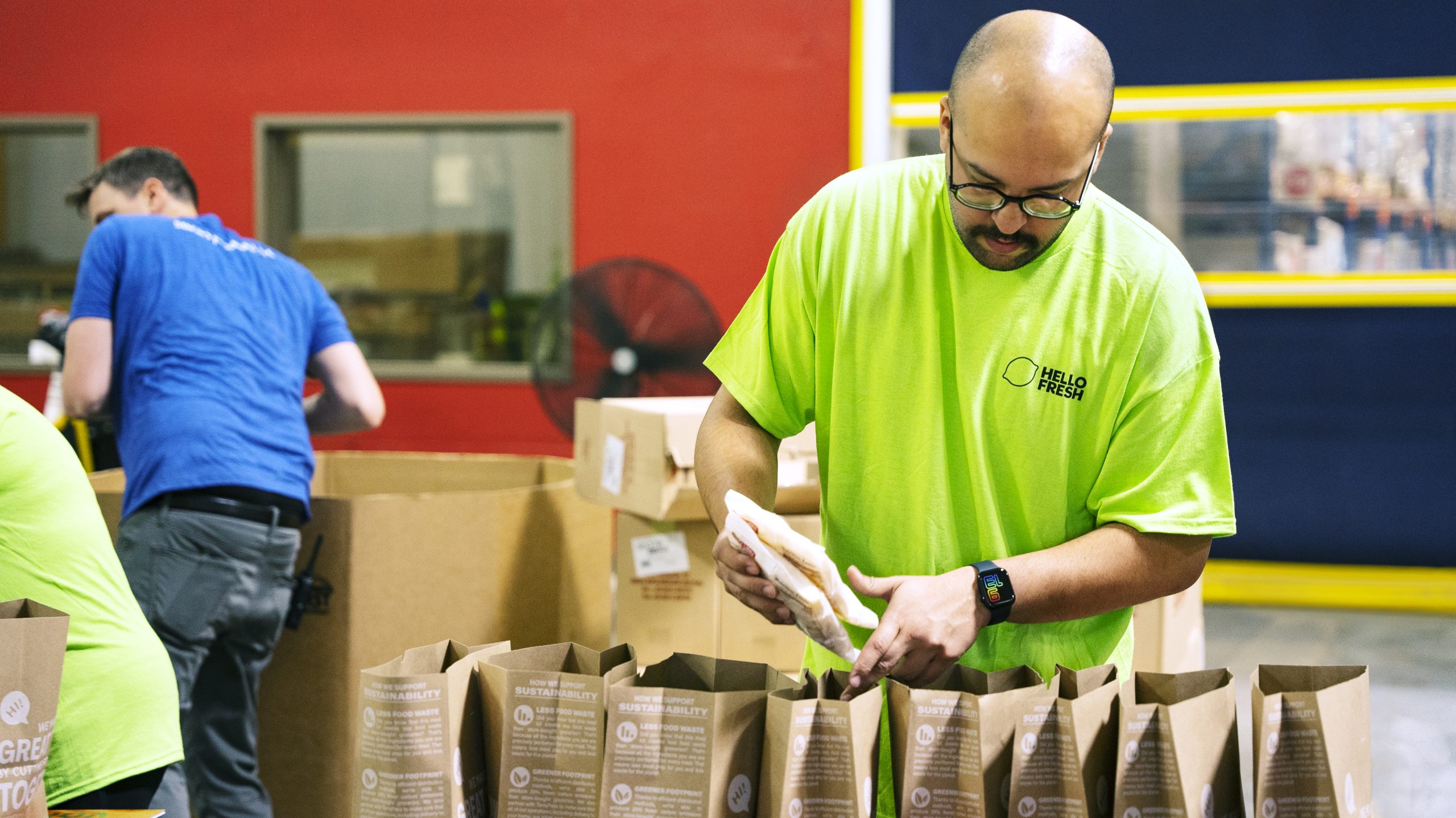 A HelloFresh team member packs donation bags, helping to provide nutritious meals to those in need.