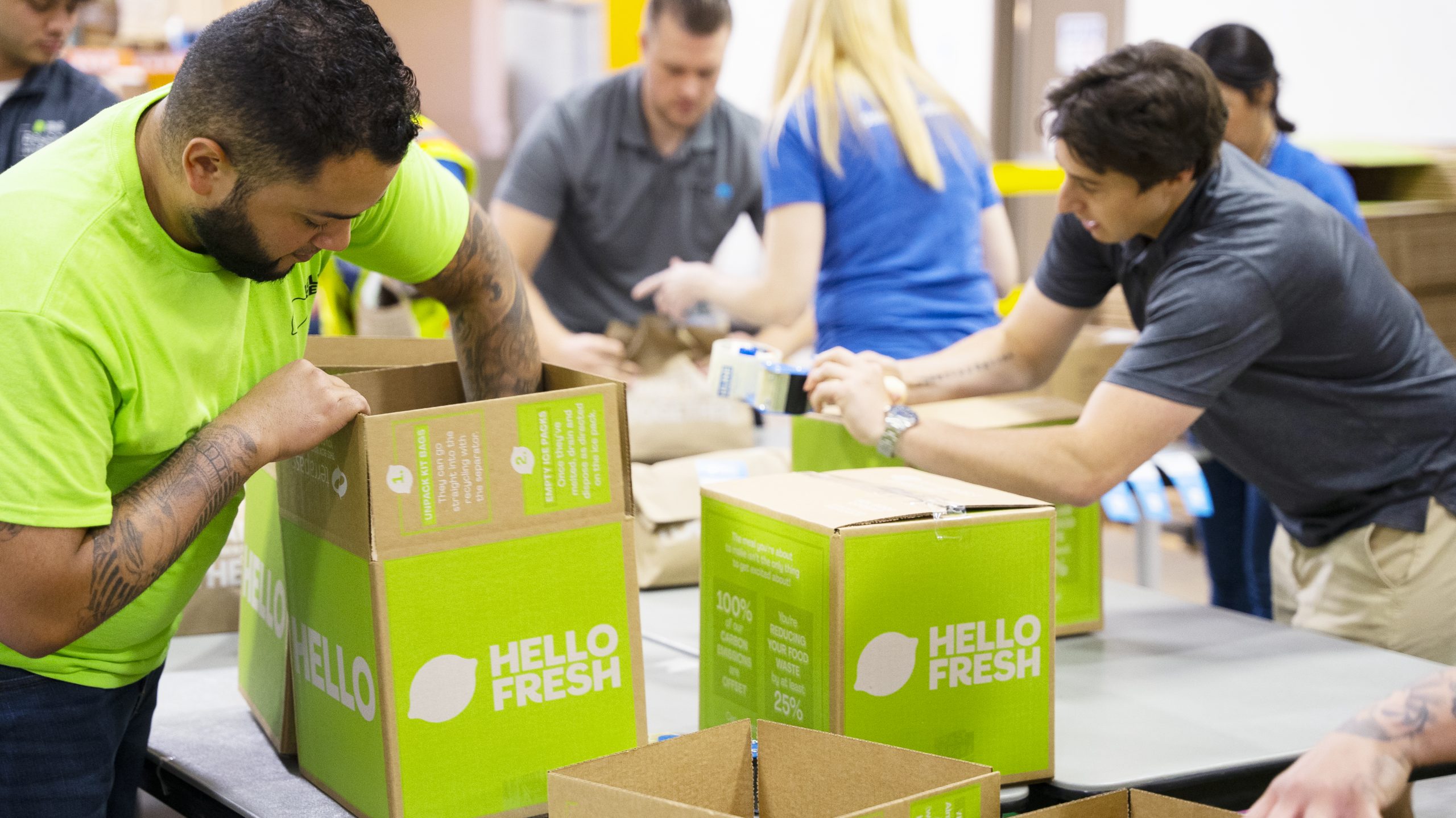 HelloFresh team members pack donation boxes to help in the fight against hunger.