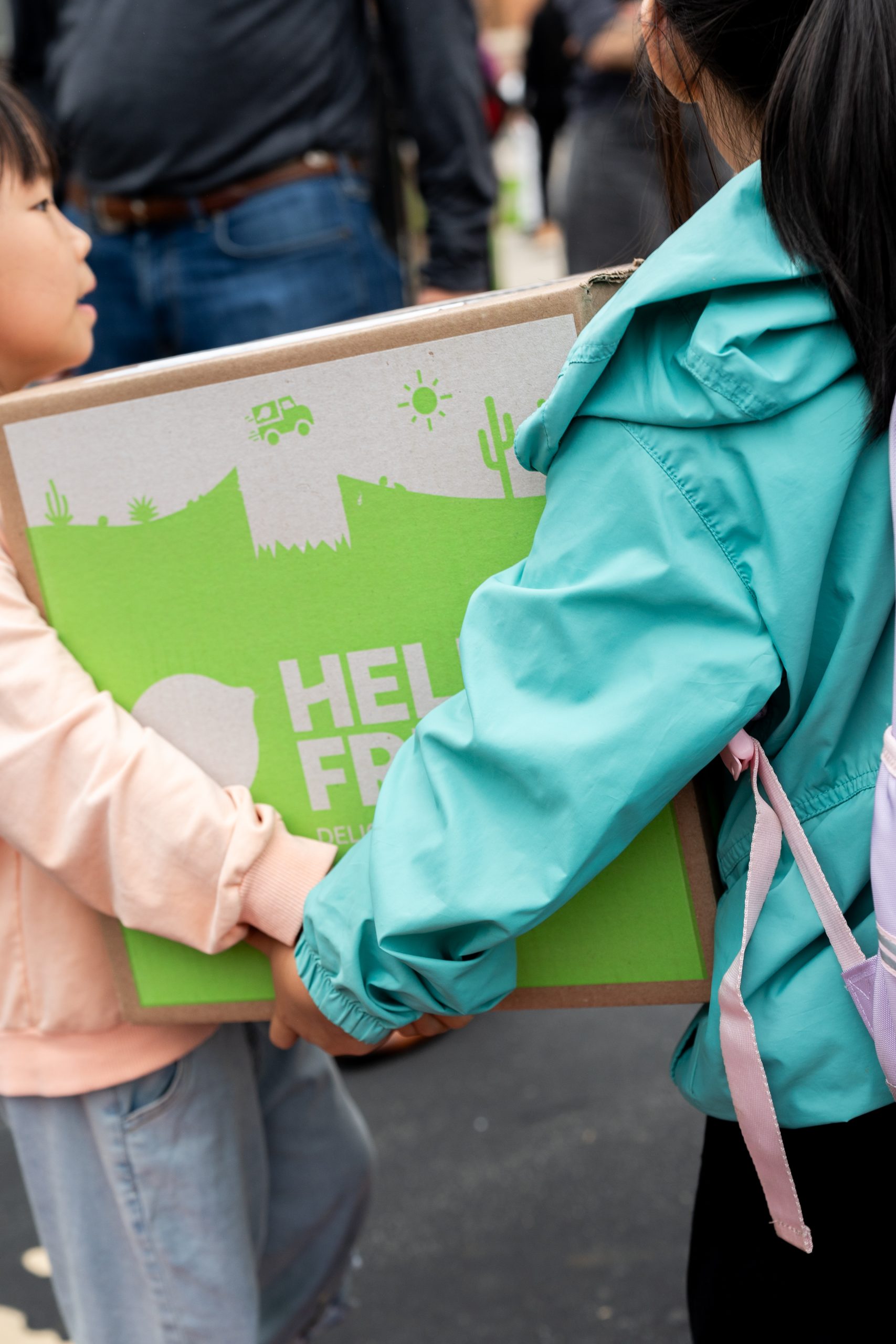 two kids carry a hellofresh box